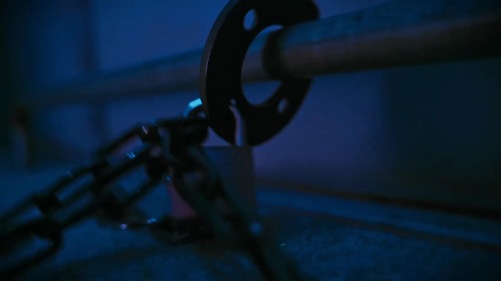 A heavy chain and shackle bolted to the floor of the Asylum cell